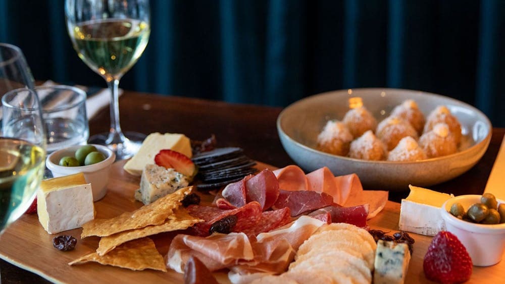 Selection of Tilba cheeses with membrillo, cornichons, muscatels and Fedra olives