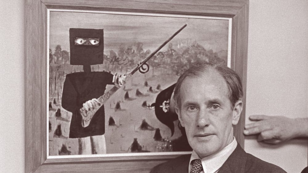 Sidney Nolan posed in front of a Ned Kelly painting for Pix Magazine